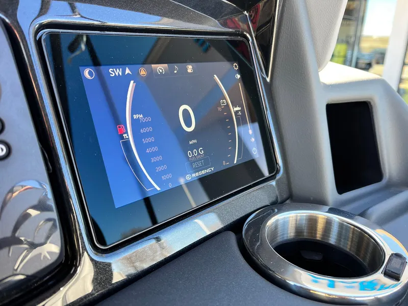 Slide: The Image of 2024 Regency 230 DL3 dashboard display with digital speedometer and cup holder. - 34