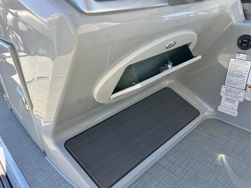 Slide: The Image of 2024 Regency 230 DL3 boat interior storage compartment and mat. - 36