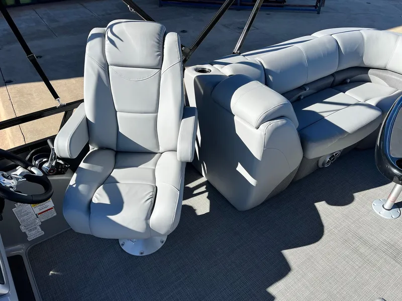 Slide: The Image of 2024 Regency 230 DL3 boat interior with gray captain's chair and seating. - 37