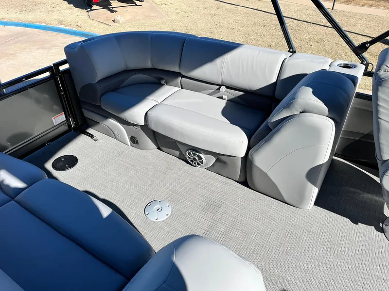 Slide: The Image of 2024 Regency 230 DL3 pontoon boat interior with gray seating and carpet. - 40