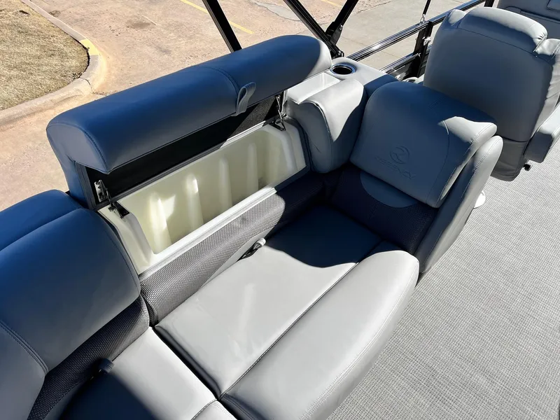 Slide: The Image of 2024 Regency 230 DL3 boat with open storage compartment and gray seating. - 41