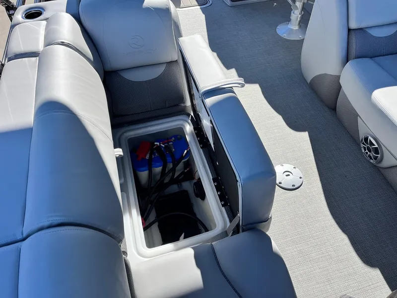 Slide: The Image of 2024 Regency 230 DL3 boat with open storage compartment and seating. - 42
