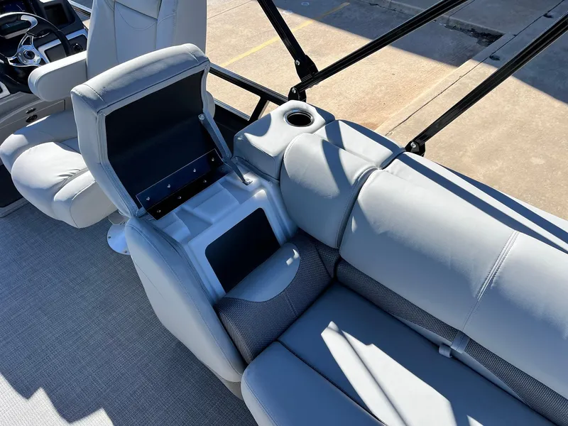 Slide: The Image of 2024 Regency 230 DL3 boat interior with gray seating and storage compartment. - 45