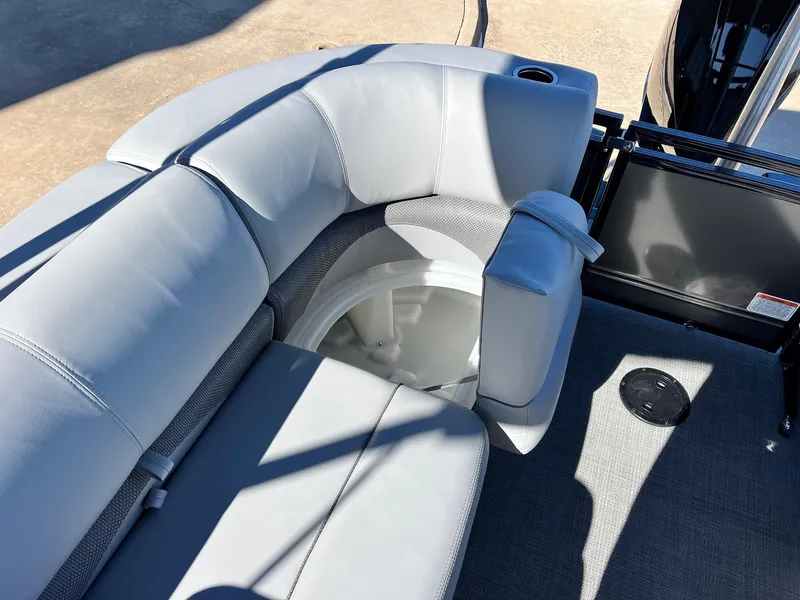 Slide: The Image of 2024 Regency 230 DL3 boat with gray cushioned seating and storage compartment. - 48