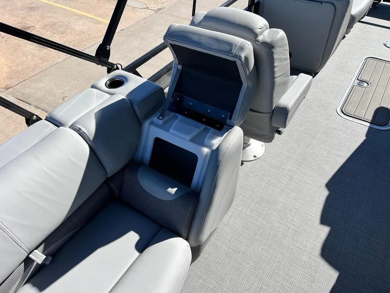 Slide: The Image of 2024 Regency 230 DL3 boat interior with gray seating and storage compartment. - 49
