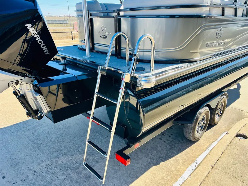 Slide: The Image of 2024 Regency 230 DL3 pontoon boat with Mercury outboard motor and boarding ladder. - 9