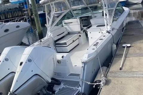 Slide: The Image of 2021 Blackfin 272DC boat docked with twin outboard engines. - 1