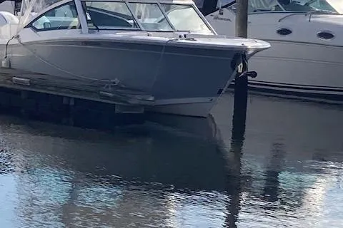 Slide: The Image of 2021 Blackfin 272DC boat docked in a marina. - 2