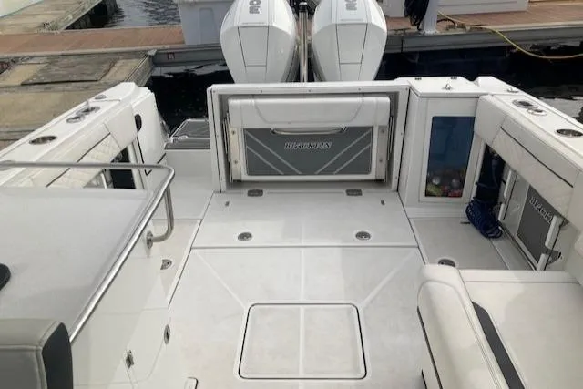 Slide: The Image of 2021 Blackfin 272DC boat deck with twin outboard engines at dock. - 3