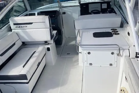 Slide: The Image of 2021 Blackfin 272DC boat interior with white seating and control panel. - 5