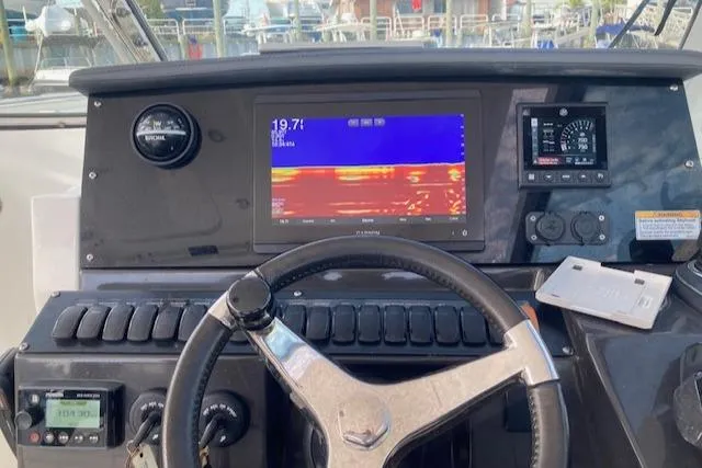 Slide: The Image of 2021 Blackfin 272DC boat dashboard with navigation and control systems. - 7