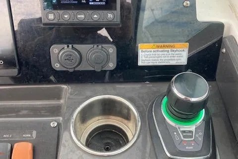 Slide: The Image of Control panel of a 2021 Blackfin 272DC boat with joystick and cup holder. - 8