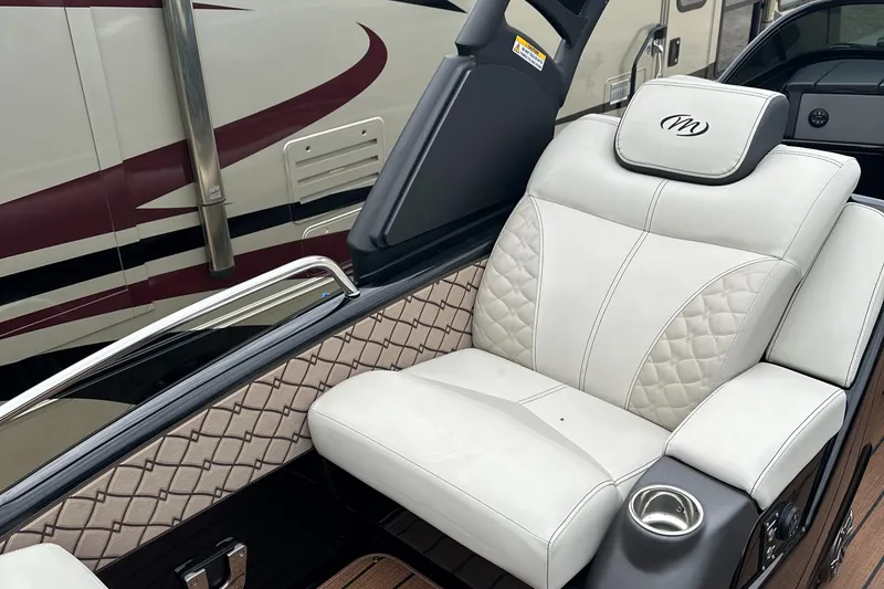 Slide: The Image of 2024 Manitou 25LX SRW boat with luxurious white leather seating. - 2