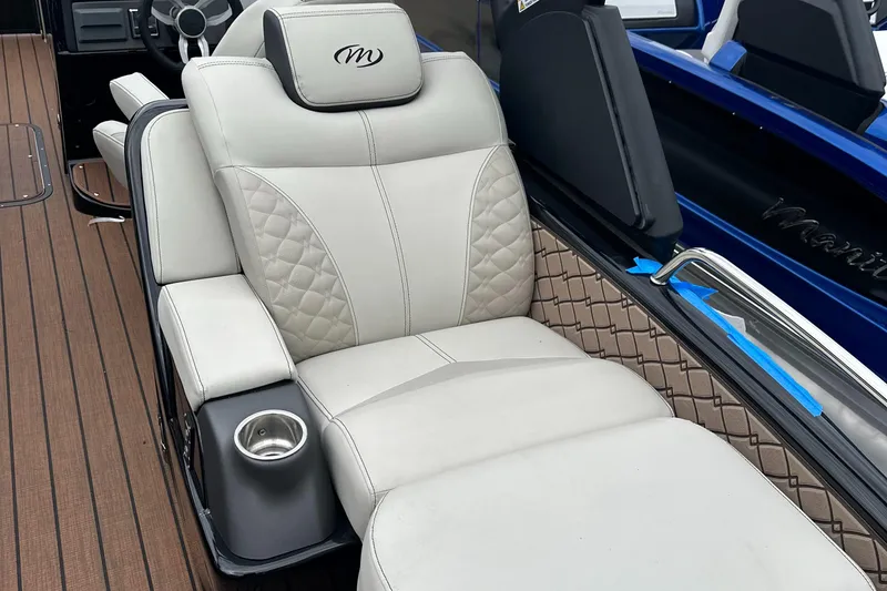 Slide: The Image of 2024 Manitou 25LX SRW boat with luxurious white leather seating and cup holder. - 3