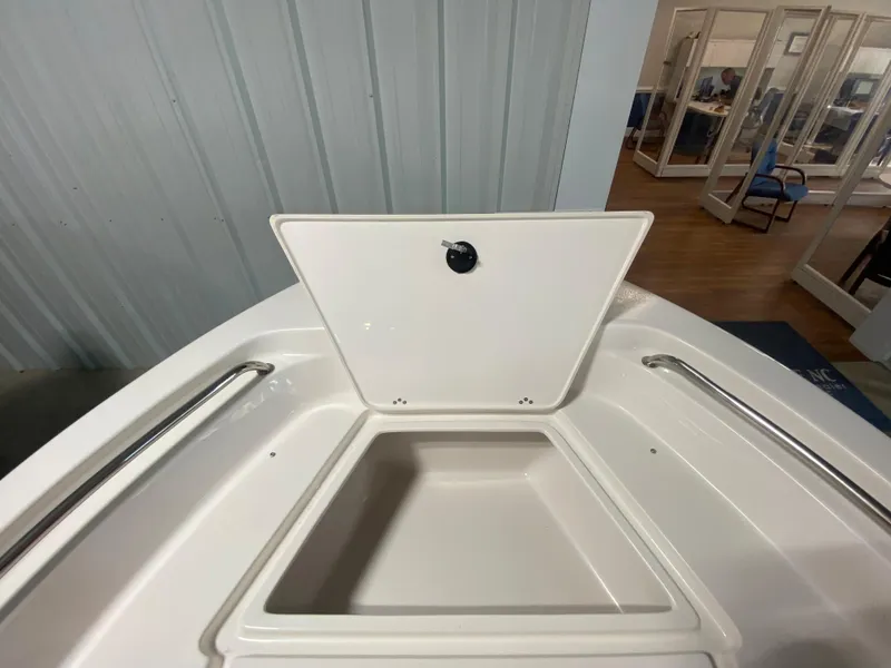 Slide: The Image of 2024 Key West 189 FS boat storage compartment with open lid. - 17
