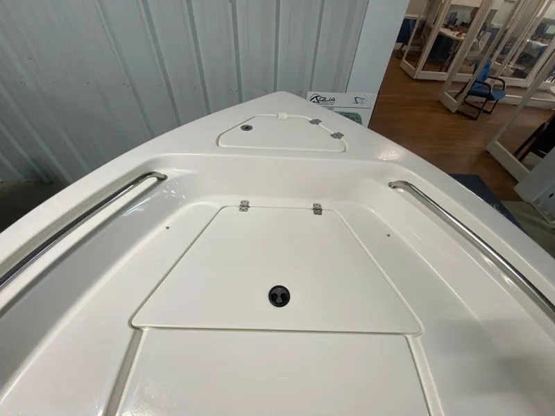 Slide: The Image of 2024 Key West 189 FS boat bow with storage compartments and stainless steel rails. - 18
