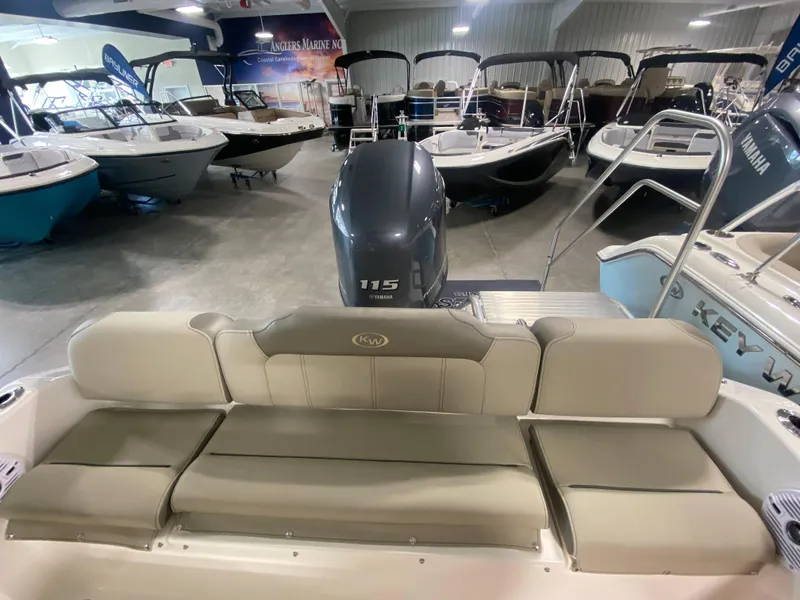 Slide: The Image of 2024 Key West 189 FS boat interior with Yamaha 115 engine in showroom. - 4