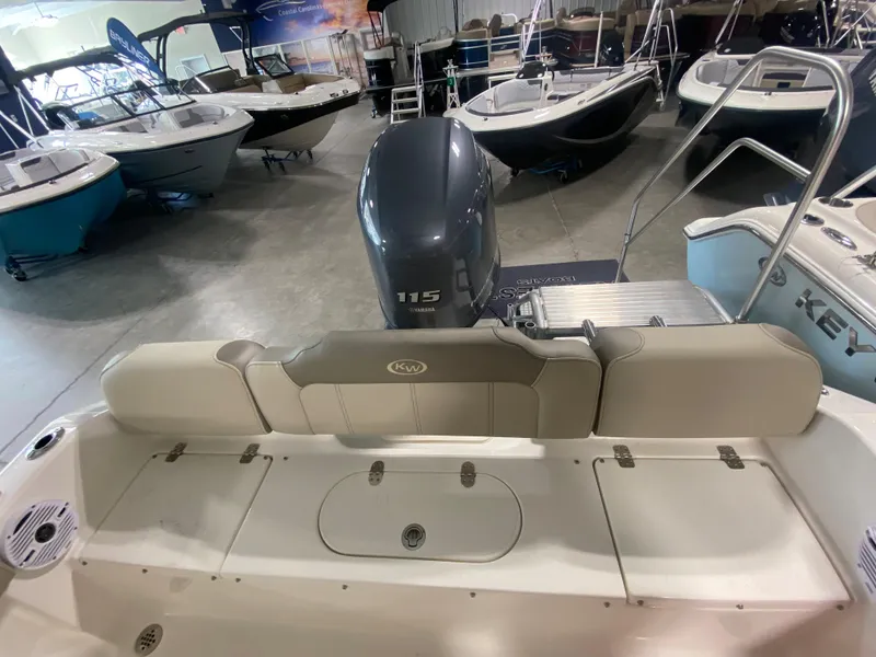 Slide: The Image of 2024 Key West 189 FS boat interior with Yamaha 115 outboard motor in showroom. - 5