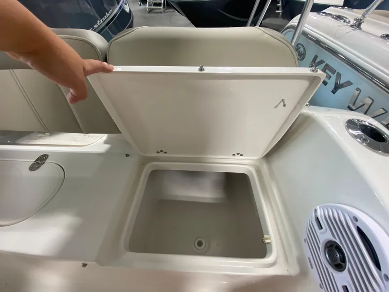 Slide: The Image of 2024 Key West 189 FS boat storage compartment with open lid and speaker. - 6