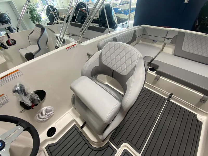 Slide: The Image of 2024 Bayliner VR4 boat interior with gray seating and modern design. - 13