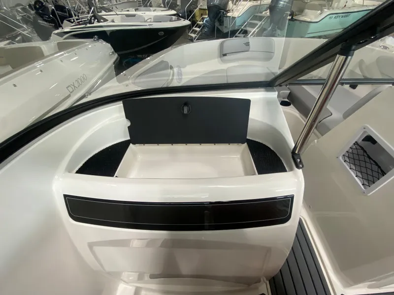Slide: The Image of 2024 Bayliner VR4 boat interior with storage compartment and windshield. - 17