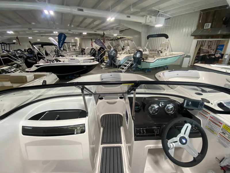 Slide: The Image of 2024 Bayliner VR4 boat interior in a showroom with other boats. - 18