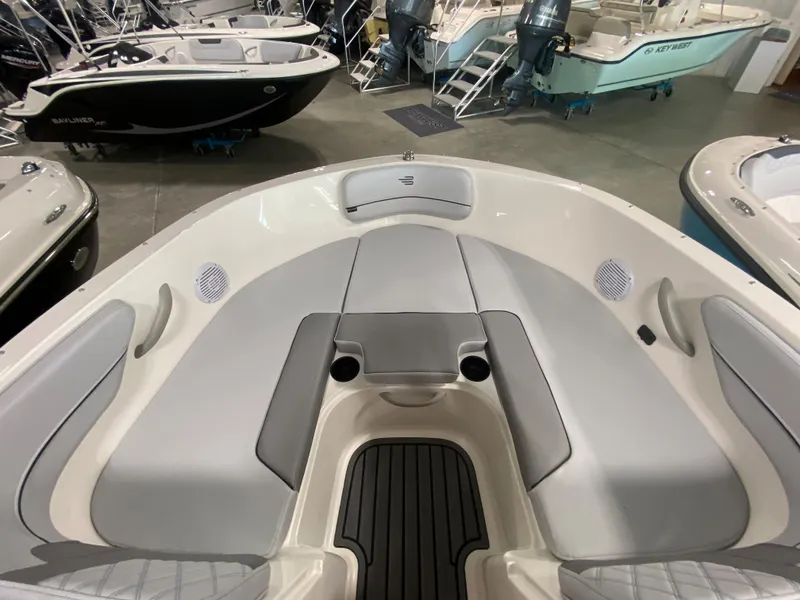 Slide: The Image of 2024 Bayliner VR4 boat interior with gray seating and cup holders. - 21