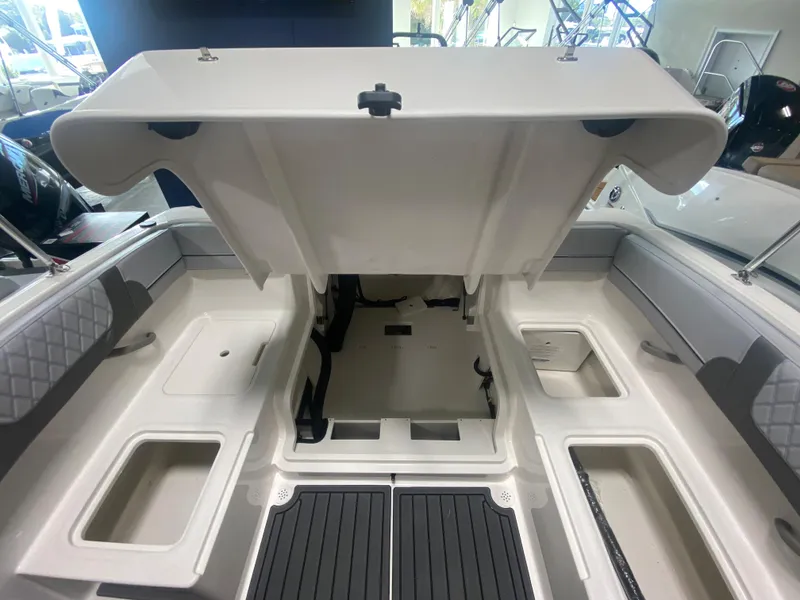 Slide: The Image of 2024 Bayliner VR4 boat interior with open storage compartments. - 9