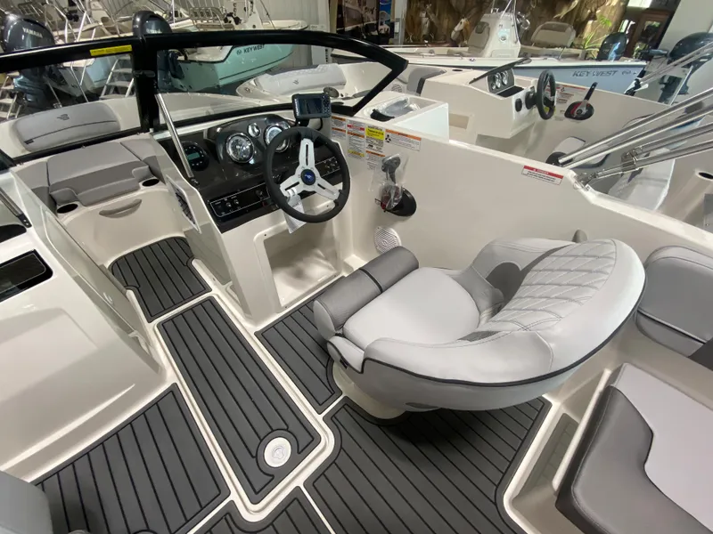 Slide: The Image of 2024 Bayliner VR4 boat interior with modern dashboard and comfortable seating. - 10