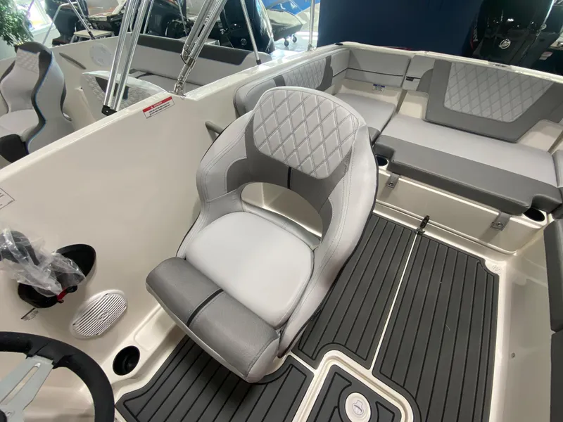 Slide: The Image of 2024 Bayliner VR4 boat interior with gray seating and modern design. - 11