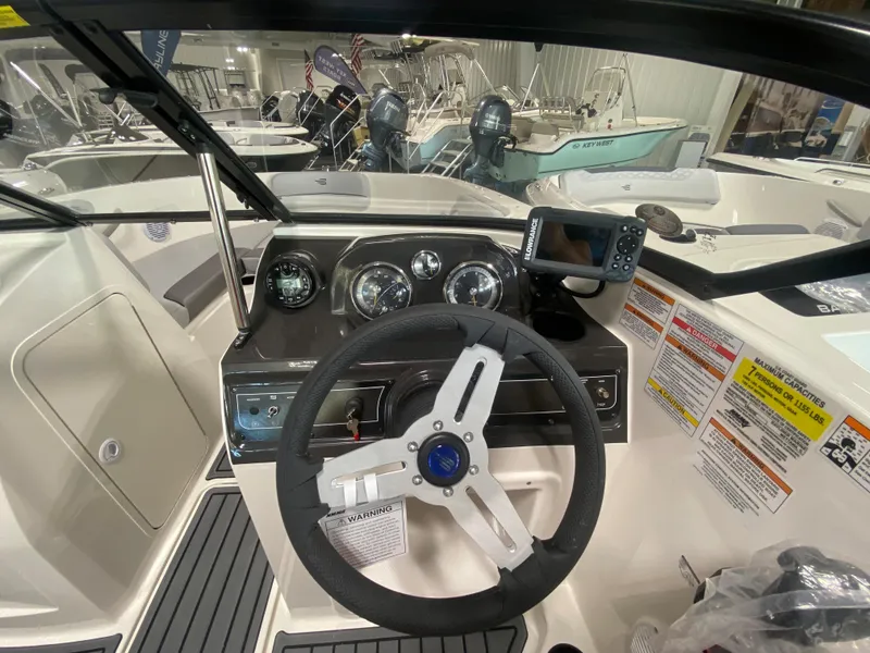 Slide: The Image of 2024 Bayliner VR4 boat dashboard with steering wheel and navigation system. - 14