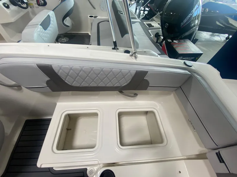 Slide: The Image of 2024 Bayliner VR4 boat interior with storage compartments and seating. - 7