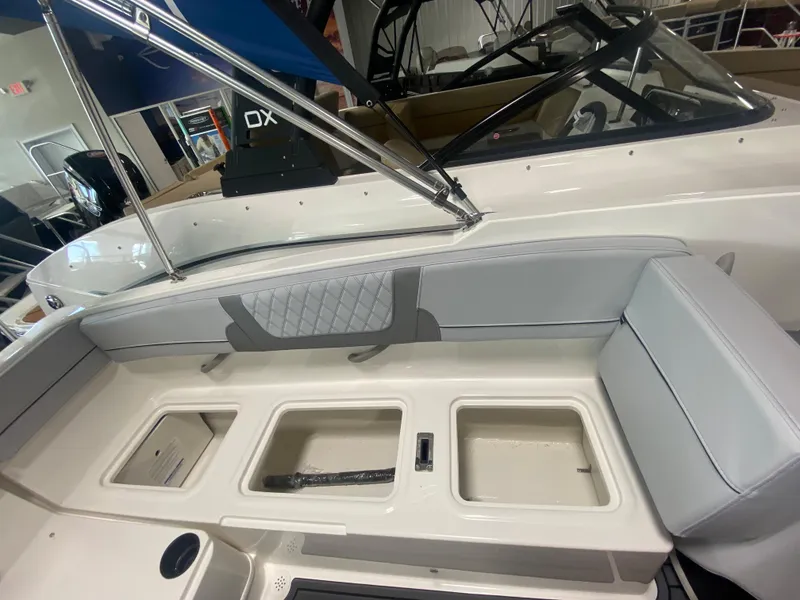 Slide: The Image of 2024 Bayliner VR4 boat interior with storage compartments and seating. - 8