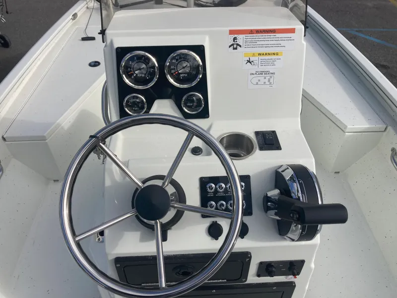 Slide: The Image of 2023 Lowe BAY 20 boat console with steering wheel and gauges. - 5