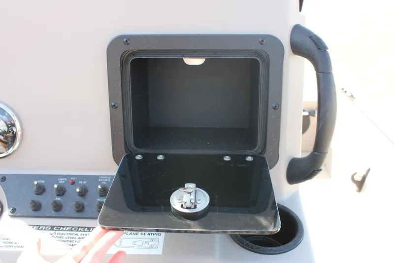 Slide: The Image of Avid 18 Rogue 2024 boat dashboard with open storage compartment. - 10