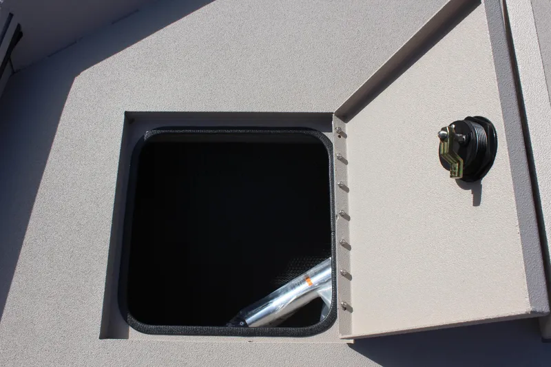 Slide: The Image of Open storage compartment on a 2024 Avid 18 Rogue boat. - 13