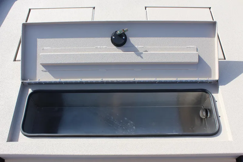 Slide: The Image of Open storage compartment of 2024 Avid 18 Rogue boat. - 15