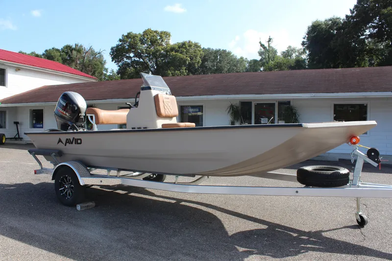 Slide: The Image of 2024 Avid 18 Rogue boat on a trailer, parked outside a building. - 4