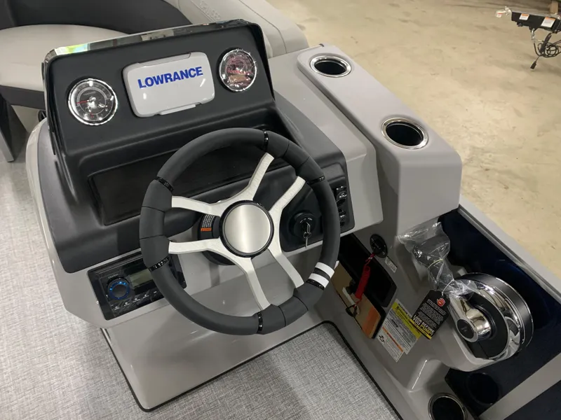 Slide: The Image of 2024 Harris Cruiser 190 boat dashboard with Lowrance display and steering wheel. - 3