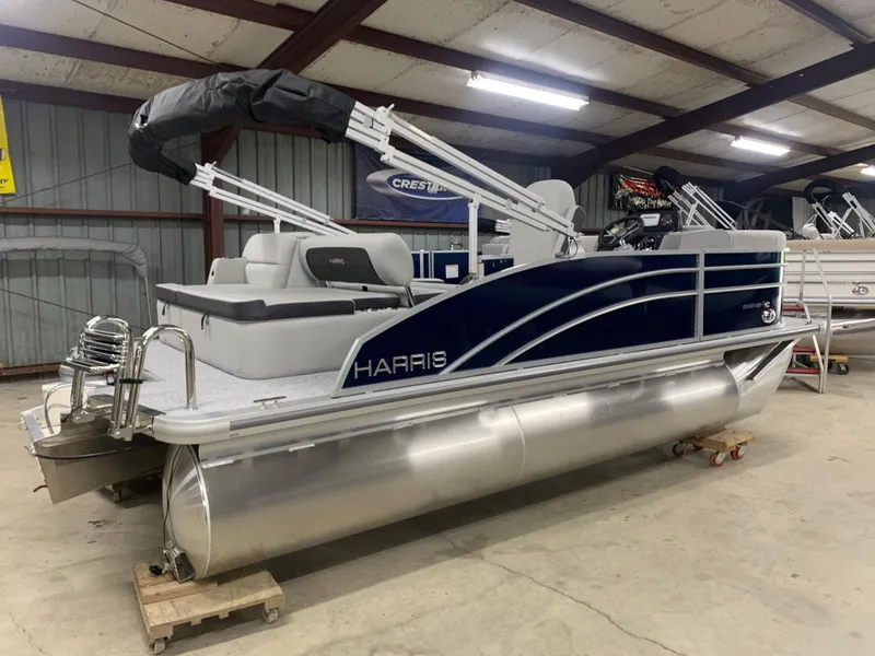 Slide: The Image of 2024 Harris Cruiser 190 pontoon boat in a showroom. - 5