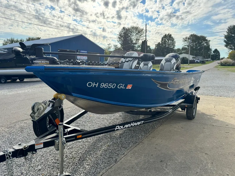 Slide: The Image of 2024 Polar Kraft Outlander 165 boat on trailer, blue hull, parked outdoors. - 9