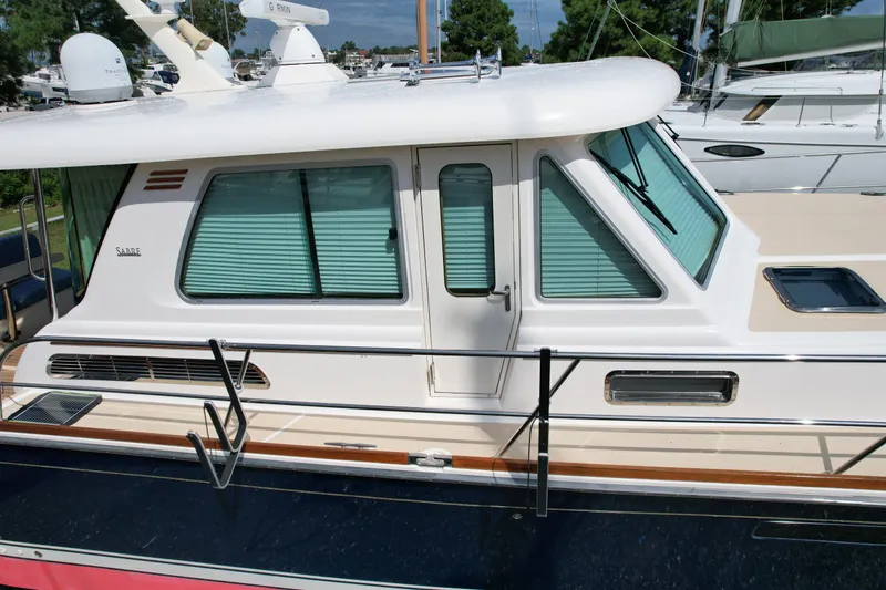 Slide: The Image of 2012 Sabre 48 Salon Express yacht with sleek design and tinted windows. - 10