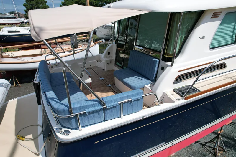 Slide: The Image of 2012 Sabre 48 Salon Express yacht with blue seating and canopy. - 11