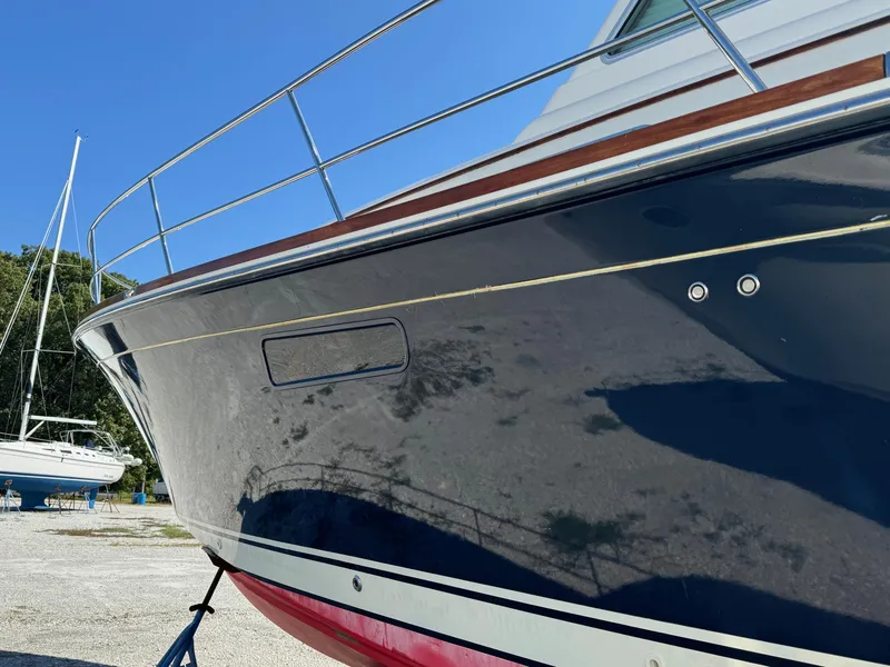 Slide: The Image of 2012 Sabre 48 Salon Express yacht, sleek hull design, docked outdoors. - 12
