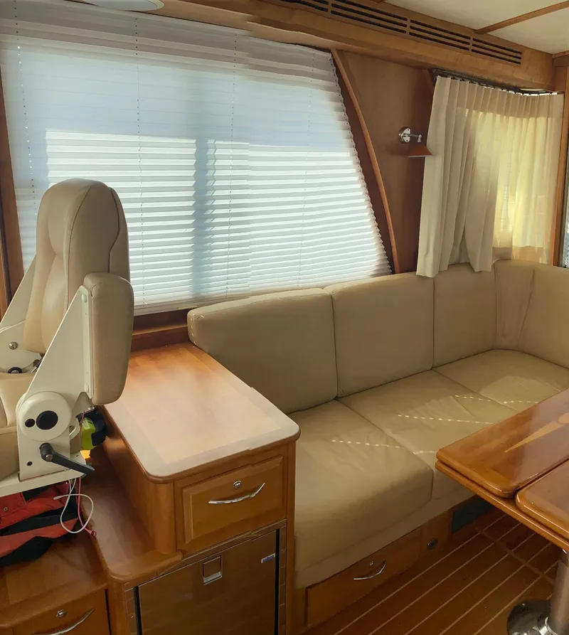 Slide: The Image of Interior of 2012 Sabre 48 Salon Express with beige seating and wooden accents. - 19