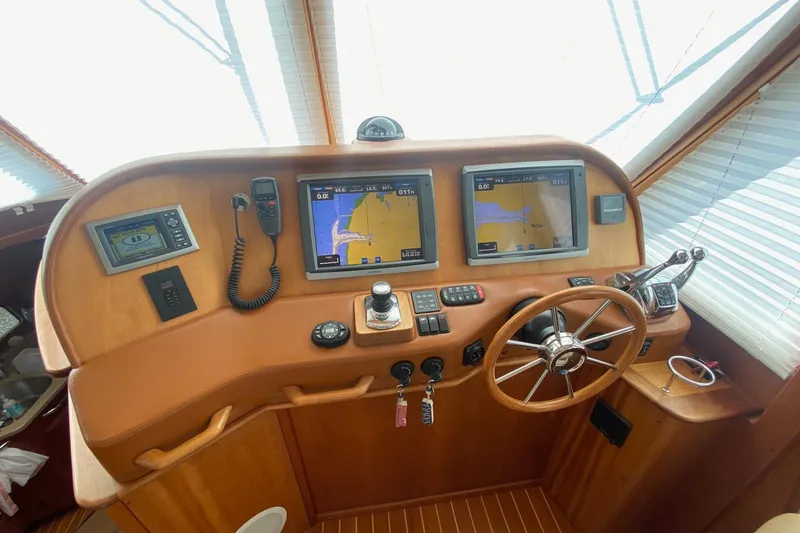 Slide: The Image of 2012 Sabre 48 Salon Express helm with navigation screens and steering wheel. - 26
