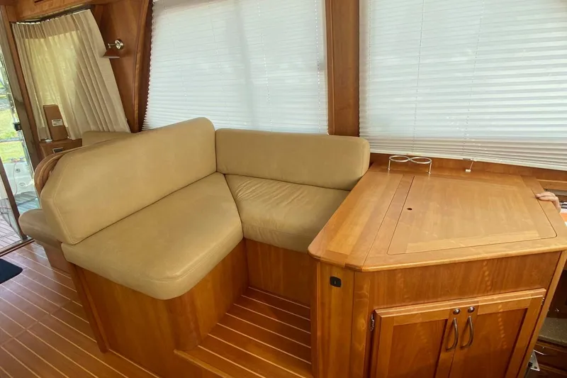 Slide: The Image of Interior of 2012 Sabre 48 Salon Express with beige seating and wooden cabinetry. - 27