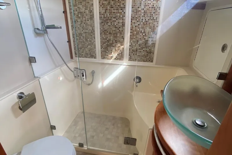 Slide: The Image of Luxurious bathroom in 2012 Sabre 48 Salon Express yacht with glass shower and modern sink. - 29