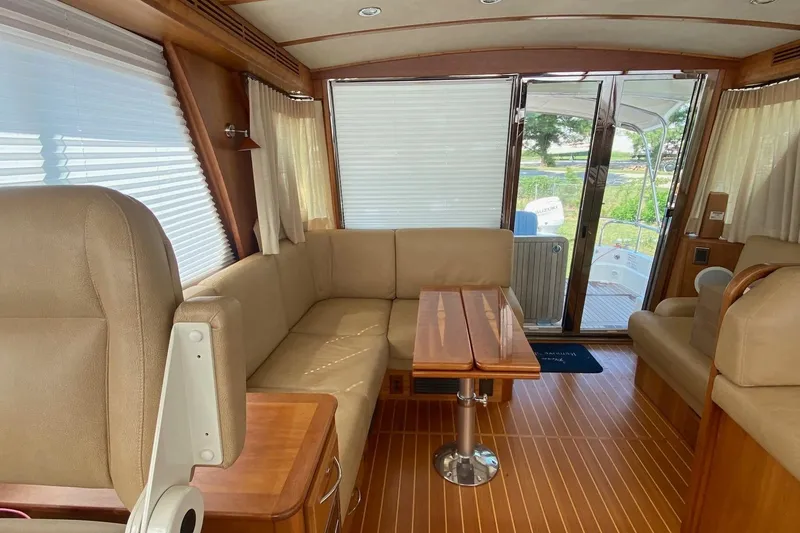 Slide: The Image of Interior of 2012 Sabre 48 Salon Express yacht with beige seating and wooden accents. - 3