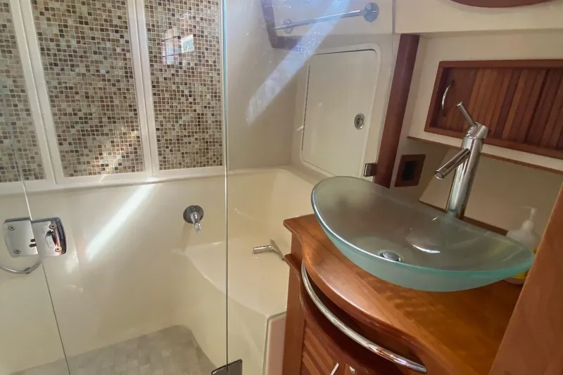 Slide: The Image of Luxurious bathroom in 2012 Sabre 48 Salon Express yacht with glass sink and mosaic tiles. - 30